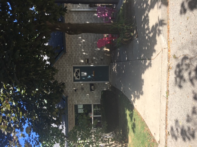 Front entrance to a unit.  There is a tree providing shade